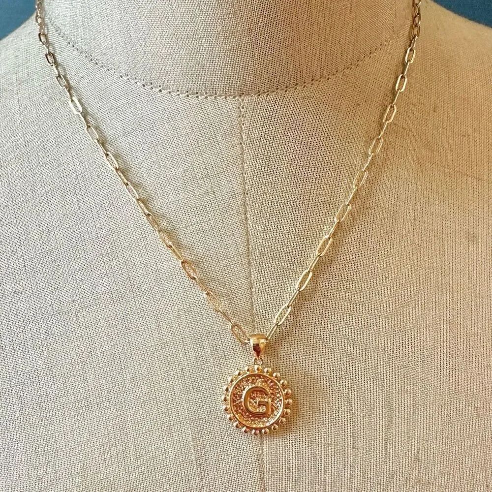 Gold tone G monogram pendant necklace